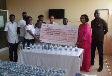 Mrs Dedjoe (second from right) presenting the cheque to officials of the unit