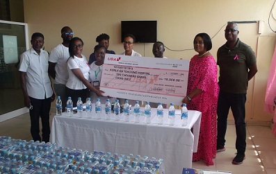 Mrs Dedjoe (second from right) presenting the cheque to officials of the unit