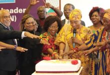 Hajia Zuweira Abudu (third from right) being assisted by other participants to cut the cake for opening of the Network