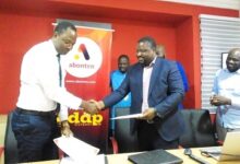 Mr Onaiviin a handshake with Mr Rufu after signing the partnership agreement