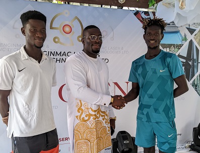 David Nyadzivor, owner of Enginmac in a handshake with Acquah (right) as Bagerbaseh looks on