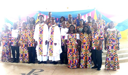 Rev. Fr Samuel Osei Kuffour (left) with the couples after the Mass Wedding Service.