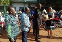 • inset, Alhaji Tufeiru (second from right) receiving the motorcycles from Ms Paulina Rozycka