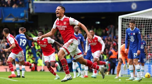 Ecstatic Arsenal players wheel away in celebration after scoring the only goal of the match