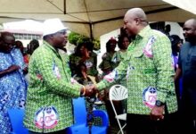 • Former President John Mahama, (right) exchanging greetings with the Moderator