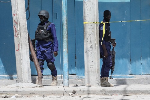 Security officers patrol at the the site of explosions in Mogadishu