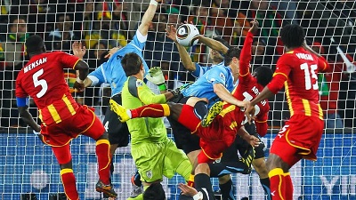Uruguay's Luis Suarez punching the goal-bound ball out of the net