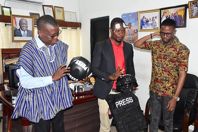 Mr Dave Agbenu (left) examining some of the items after the presentation.With him are Mr Latif (middle) and Mr Emmanuel Ayine