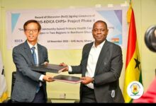 • Dr Kuma-Aboagye and Mr Kong exchanging copies of the signed document.