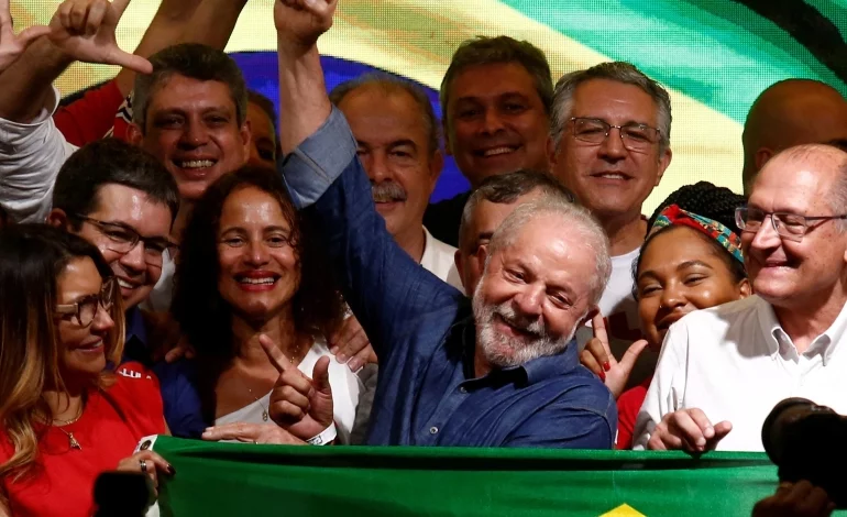 Inacio Lula da Silva waves at his supporters after being elected president in Sunday's election
