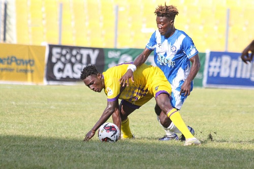 Medeama SC player Prosper Owusu Boakye in a tussle for the ball with Oly's Ibrahim Sulley (in blue and white) Photo Raymond Ackumey