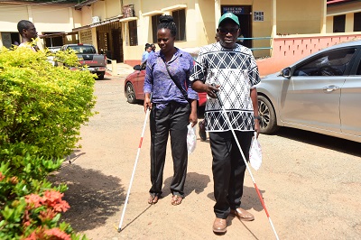 Some blind persons with the aid of the white cane