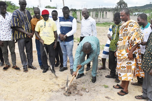 Mr Dadzie cutting the sod at Aboso. With him standing in kente is Nana Brekrom