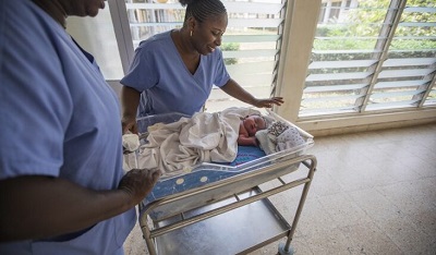 Some nurses taking care of a new born baby