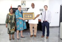 Mr Quartey (second from right) presenting a gift to Ms Palmer (second from left) after the visit
