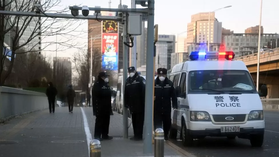Police by the Liangma river bridge in Beijing on Tuesday - the location of a protest over the weekend.