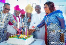 Dr Bawumia(second right) and Nii Adjiri-Blankson (left) helping the clergy led by Rev Dr Torto to cut the anniversary cake