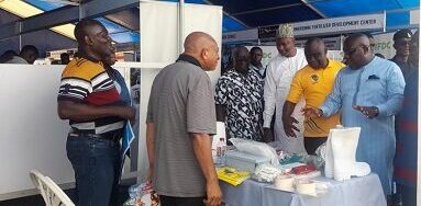 Mr Acheampong wih some dignitaries inspecting one of the stands at the fair