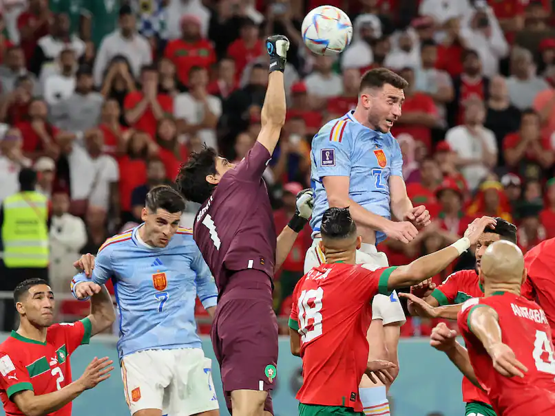 Bono (second left) is challenged aerially by Spain's Amyeric Laporte