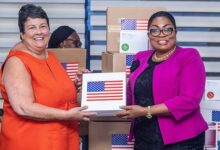 • Ms Palmeron (left) handing over the items to an official from