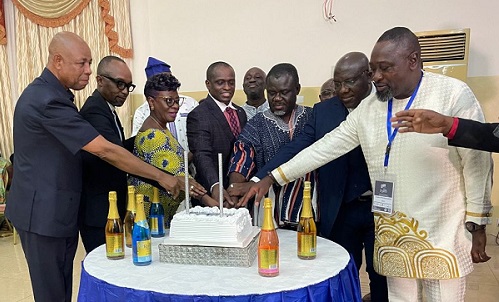 Mr. Kwaku Ofor iAsiamah (in smock) with other officials cutting the cake