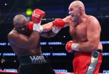 Fury (right) delivers a right punch to the face of Chisora
