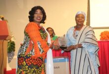 • Ms Abudu (left) presenting a plaque to Hajia Adam