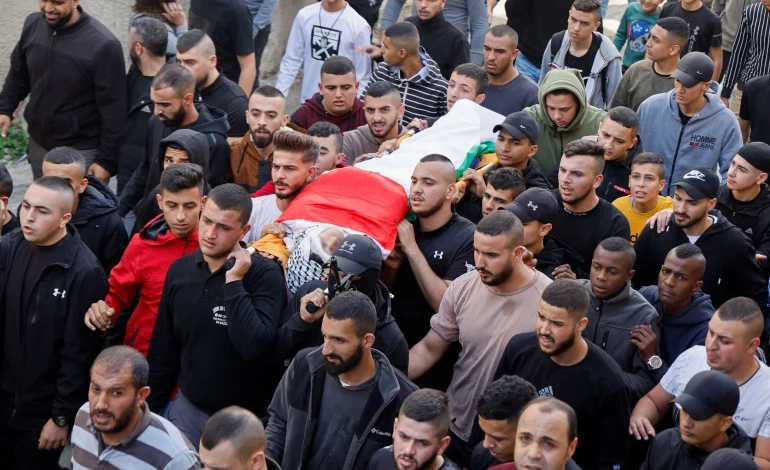 • Jana Majdi Zakarneh’s body being carried for burialher