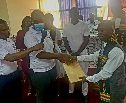 Madam Nyarkoa Addo (second from left) handing over document to Nana Agyemang Ofori President of MOMAG