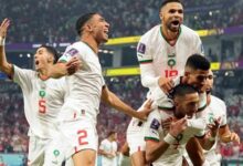 Moroccan players mob Ziyech after scoring one of the Lions' goals