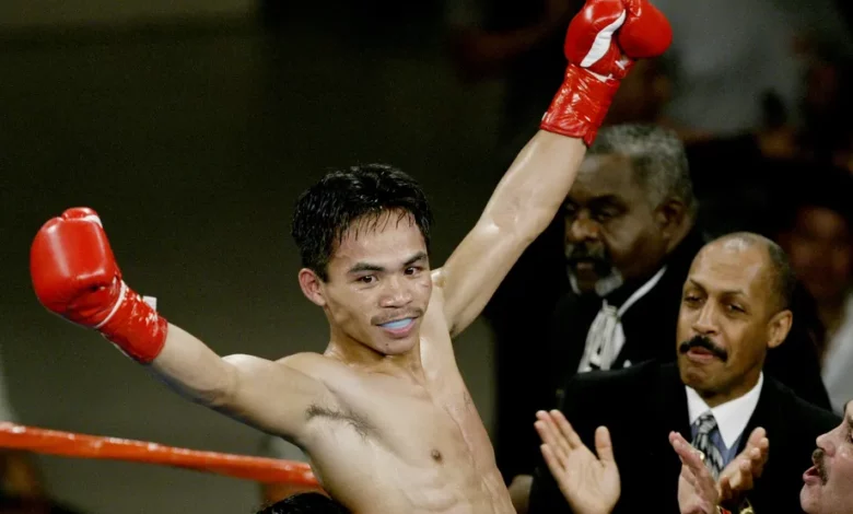Pacquiao celebrating his victory over Hussein in 2000.