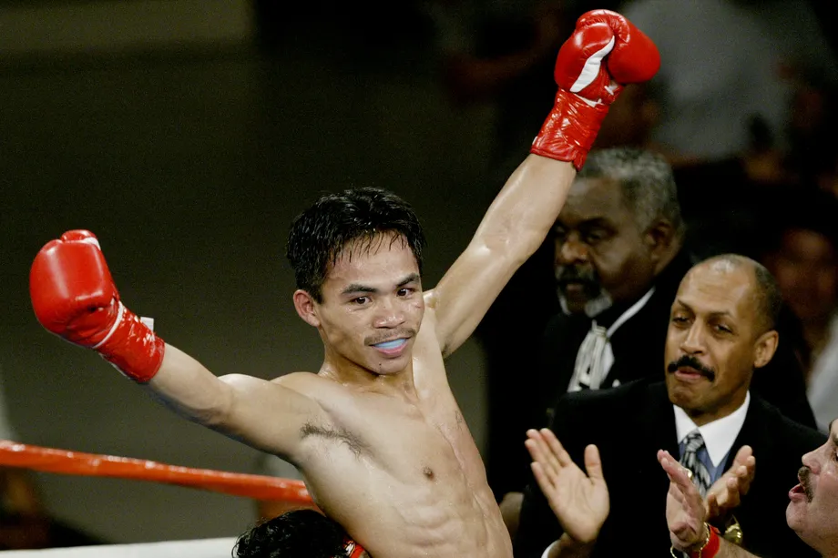 Pacquiao celebrating his victory over Hussein in 2000.