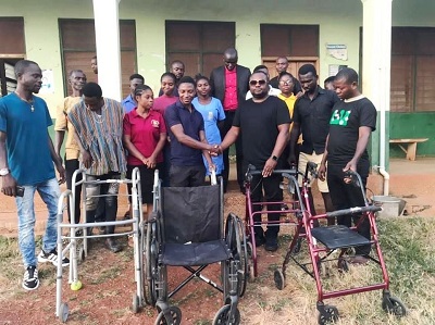 Pius Opou (right) handing over the equipment to the leadership of some of the facilities