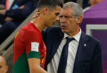 Portugal coach Fernando Santos explains a point to Ronaldo after the substitution