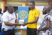 • Patrick D. Chisanga (left) making the presentation to the in-charge of the health facility