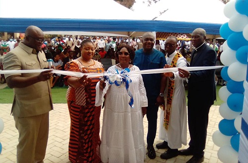 • Mrs Elizabeth Orleans-Lindsay (middle) being assisted by other dignitaries to cut the tape to open the facility Photo: Seth Osabukle