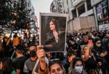 A protester holds a picture of Mahsa Amini during protests in Turkey last month