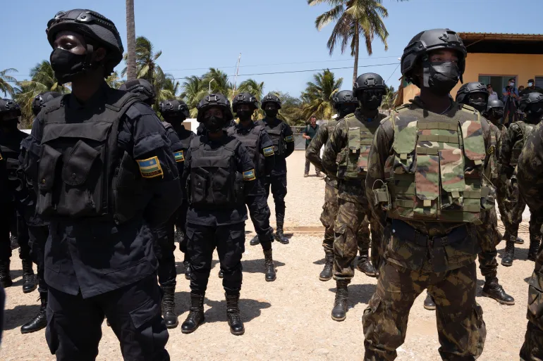 • Mozambican soldiers, (right), and Rwanda policemen, (left), stand in the Cabo Delgado province of Mozambique