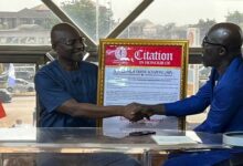 • Mr Agyapong (left) receiving the citation from Professor Addai-Mensah