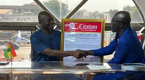 • Mr Agyapong (left) receiving the citation from Professor Addai-Mensah