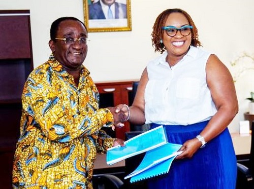 • Dr Owusu Afriyie Akoto handing over documents to Mavis Hawa Koomson