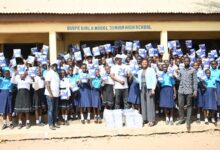 • Some of the students from the beneficiary schools with their books. Photo: Geoffrey Buta