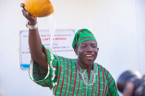 • Mr Lamtiig Apanga with a calabash of water after the inaugurationover