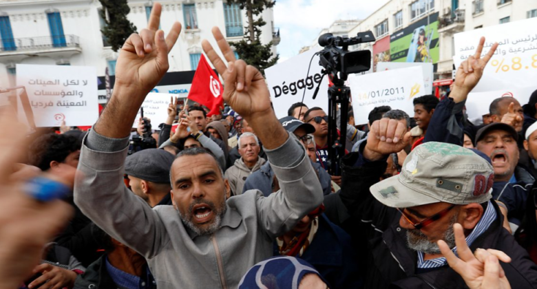 • Protesters push through police barricades in the capital, Tunis