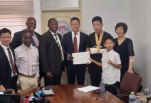 • Mr Mensah (second left), Mr Shen (fourth right) and his family exchanging the MoU with Dr Ampomah (fourth left) after the launch and signing ceremony