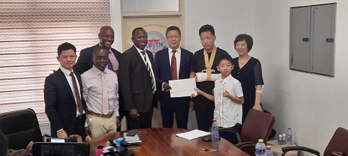 • Mr Mensah (second left), Mr Shen (fourth right) and his family exchanging the MoU with Dr Ampomah (fourth left) after the launch and signing ceremony