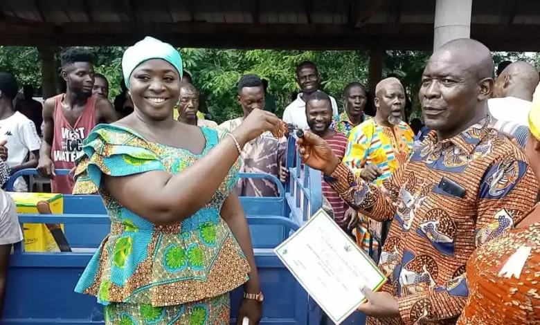 • Mr Quainoo (right) receiving a key for a tricycle and certificate