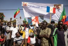 • Demonstrators hold placards during a protest to support Burkina Faso's Captain Ibrahim Traore, and to demand the departure of France's military forces