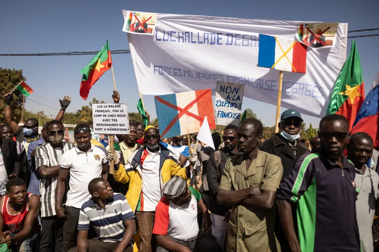 • Demonstrators hold placards during a protest to support Burkina Faso's Captain Ibrahim Traore, and to demand the departure of France's military forces