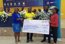 • Robert Siaw (middle) presenting a dummy cheque to Ms Esther Dede Azzu (left)